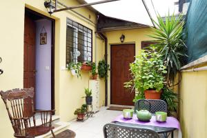 a patio with a table and chairs in front of a house at Dea Cibele in Rome