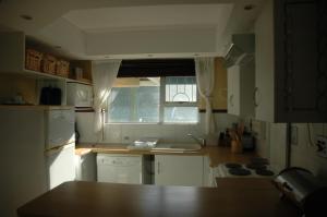 a small kitchen with a sink and a window at Ramsgate Palms H in Ramsgate