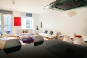 a living room with white furniture and a rug at Reykjavik4You Apartments in Reykjavík