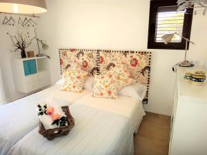 a bedroom with a bed with flowers on it at cansantidesmonestir in La Mola +38 photos