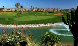 a group of people playing golf on a golf course at Hôtel Riad Airport Marrakech in Marrakech