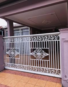 a white fence with a gate on a house at Bayan Baru Homestay @ Taman Sri Nibong in George Town