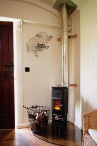 a living room with a stove in a room at The Huts in the Hills in Llanigon
