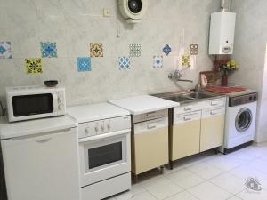 a kitchen with a sink and a microwave at Casa Tere in Sigüenza
