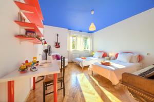 a room with two beds and a table in it at Feeling good Apartment in Rijeka