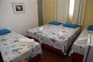 a room with two beds with towels on them at The Hotel in Teresina