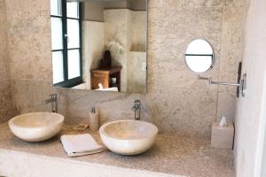 a bathroom with two sinks and a mirror at Hofgut Holzmuhle in Germersheim
