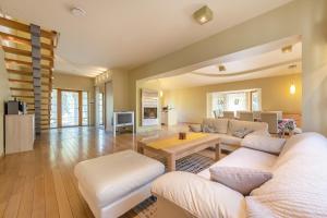 a living room with a couch and a table at Villa EverGreen near the city center with private garden, hot tub, garage parking, patio in Vilnius