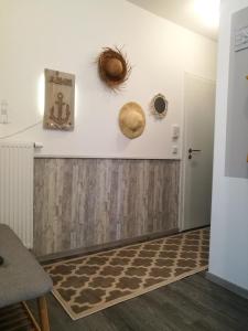 a room with white walls and a wooden wall with hats on the wall at Ferienwohnung Südterrasse mit Kamin Bj 2019 in Timmendorfer Strand
