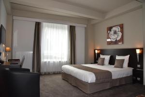 Säng eller sängar i ett rum på Hotel Saint Daniel