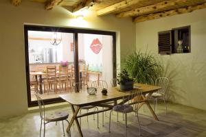 a dining room with a wooden table and chairs at cansantidesmonestir in La Mola