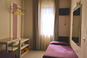 Postel nebo postele na pokoji v ubytování Hotel Mondial