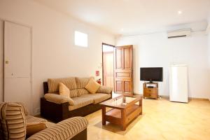 a living room with a couch and a coffee table at Hotel la Vila in Sóller