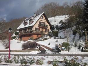 a large house on a snow covered hill with at Chambres d'hôtes "Au Val Séjour" in Saint-Martin