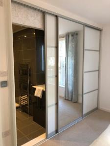 a sliding glass door with a mirror in a room at Edinburgh Old Town in Edinburgh +12 photos