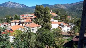 a village with houses and mountains in the background at Villa Artemis and apartments in Alagonía