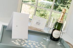a table with a bottle of champagne and two glasses at Shellbraes Studio in Ryal