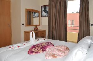 una camera da letto con un letto con due cuscini sopra di Appart-Hotel SOFINES ad Agadir