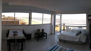 a bedroom with a bed and a view of the ocean at Terraza Marina in Ostende