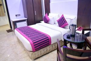 Postel nebo postele na pokoji v ubytování Hotel Sun International