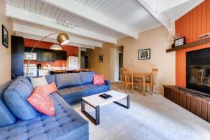 a living room with a blue couch and a fireplace at One-Bedroom Sundowner Condo T4 in Breckenridge