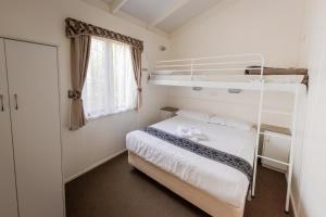 a bedroom with two bunk beds and a window at BIG4 Breeze Holiday Parks - Eildon in Eildon