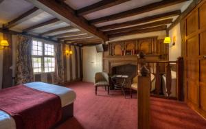 a hotel room with a bed and a table at Dog & Partridge by Chef & Brewer Collection in Tutbury
