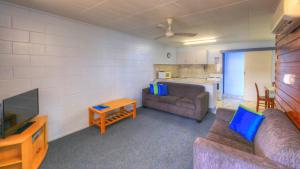 a living room with a couch and a tv at Sky View Units Bowen in Bowen