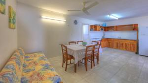 a kitchen and dining room with a table and chairs at Sky View Units Bowen in Bowen