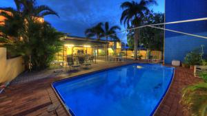 a swimming pool in a backyard with a house at Sky View Units Bowen in Bowen