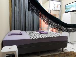 Een bed of bedden in een kamer bij Apartamento Temporada Amazonas