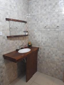 a bathroom with a sink and a shower at Pousada Vó Julia in Urubici