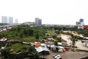 a view of a city with buildings and a parking lot at Pool View 2BR Mutiara Bekasi Apartment By Travelio in Bekasi