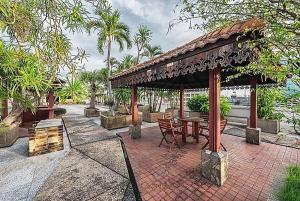 a pavilion with a table and chairs on a brick patio at Capital Mansion - SHA Certified in Bangkok