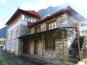 a large stone building with windows and a roof at Lukla Airport Resort Lukla in Lukla