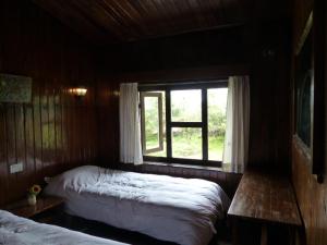 A bed or beds in a room at Lukla Airport Resort Lukla
