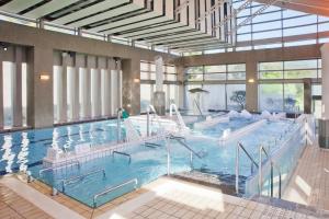 a large indoor swimming pool in a building at Miyako Resort Okushima Aqua Forest (Hotel Kintetsu Aqua Villa Ise Shima) in Shima