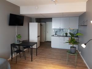 a kitchen and dining room with a table and a refrigerator at Apartments Uppsala - Portalgatan in Uppsala