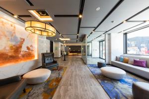 an office with a lobby with couches and a tv at Via Inn Nagoya Station Tsubaki-cho in Nagoya