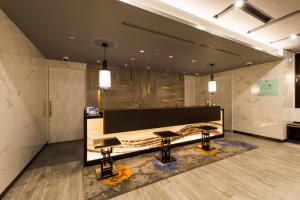 a lobby with two tables in a room at Via Inn Nagoya Station Tsubaki-cho in Nagoya