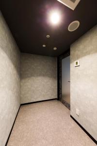 an empty room with a door and a ceiling at Via Inn Nagoya Station Tsubaki-cho in Nagoya
