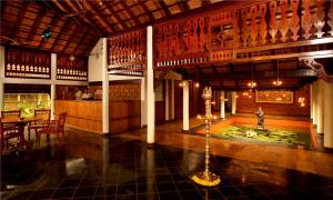 a room with a fountain in the middle of a building at Punnamada Resort in Alleppey