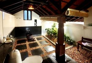 a large room with a floor with a fountain in it at Punnamada Resort in Alleppey