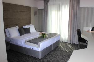 a bedroom with a bed with a flower on it at Anka Premium Hotel in Istanbul