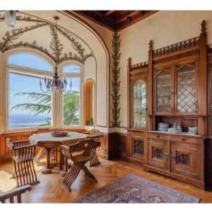 a dining room with a table and a large window at Il Parco e gli Affreschi in Varese