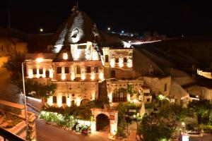 an old building with lights on it at night at Ascension Cave Suites - Special Class in Goreme