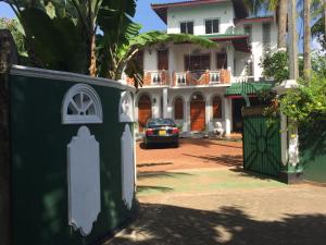 a car parked in front of a house at Accoma Villa in Hikkaduwa