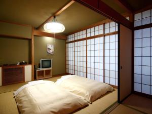 Una cama o camas en una habitación de Breezbay Seaside Resort Atami