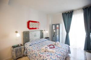 a bedroom with a bed with towels on it at Versomare in Polignano a Mare