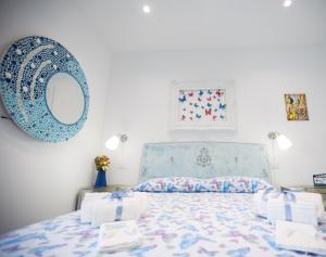 a bedroom with a bed and a mirror on the wall at Versomare in Polignano a Mare